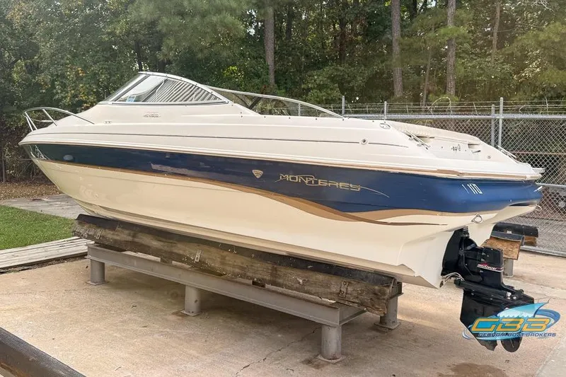 Slide: The Image of 1998 Monterey 236 Montura boat on display, featuring a sleek design and blue accents. - 3