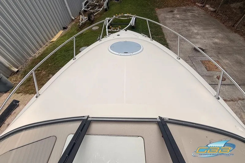 Slide: The Image of 1998 Monterey 236 Montura boat deck with railing and hatch, parked outdoors. - 5