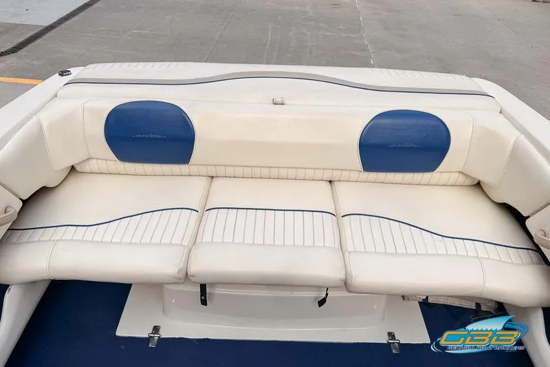 Slide: The Image of 1998 Monterey 236 Montura boat interior with white and blue seating. - 7