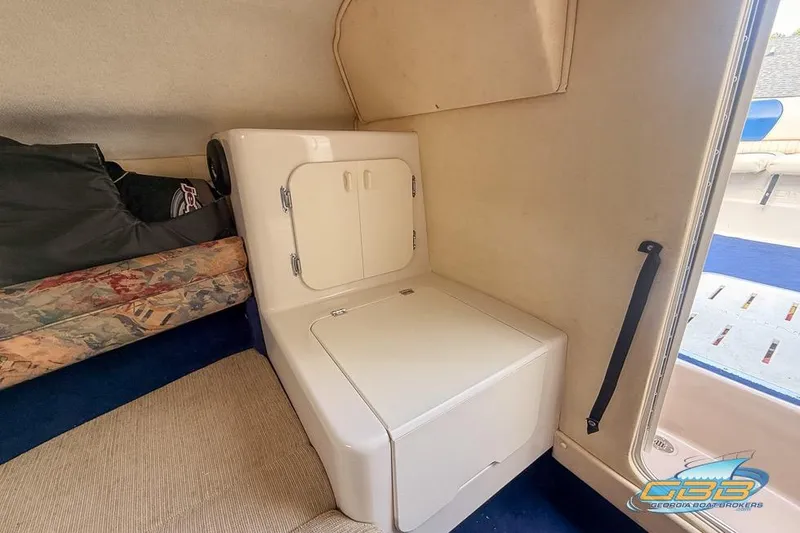 Slide: The Image of Interior of 1998 Monterey 236 Montura boat with storage compartment and seating area. - 9