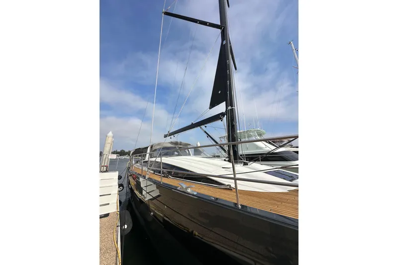 Slide: The Image of 2017 Jeanneau 64 yacht docked, showcasing sleek design and modern features. - 10