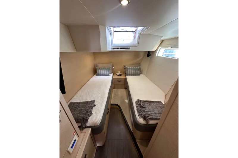 Slide: The Image of Luxurious 2017 Jeanneau 64 yacht cabin with twin beds and skylight. - 100