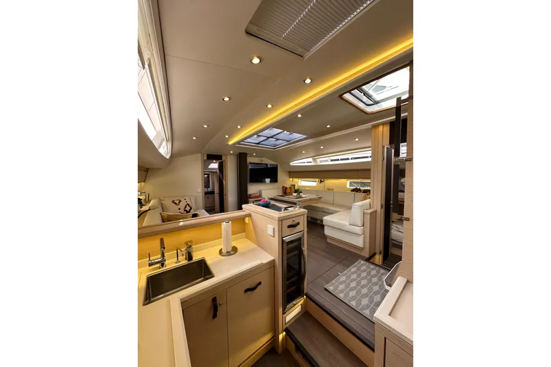 Slide: The Image of Luxurious interior of 2017 Jeanneau 64 yacht, featuring modern kitchen and spacious seating area. - 104