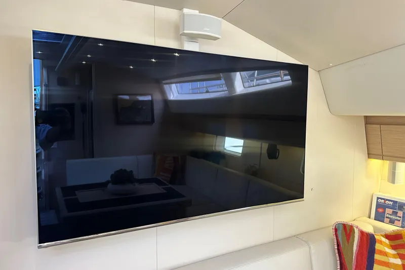 Slide: The Image of Interior of 2017 Jeanneau 64 yacht featuring a mounted flat-screen TV. - 110