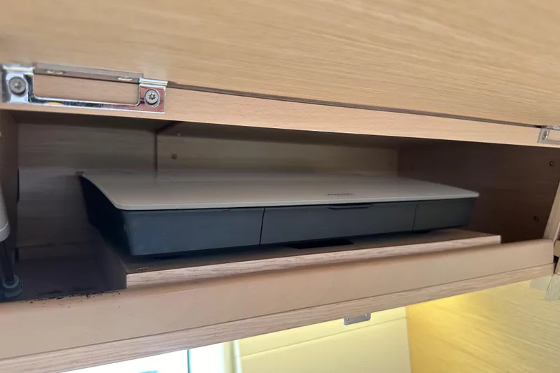 Slide: The Image of Wooden cabinet with a printer inside on a 2017 Jeanneau 64 yacht. - 111