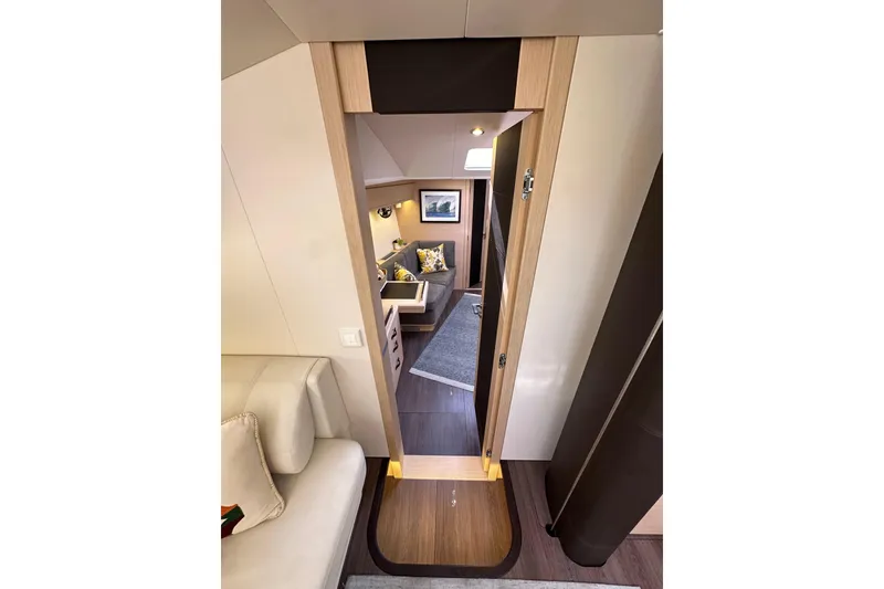 Slide: The Image of Interior of 2017 Jeanneau 64 yacht, featuring a cozy cabin with modern decor. - 114