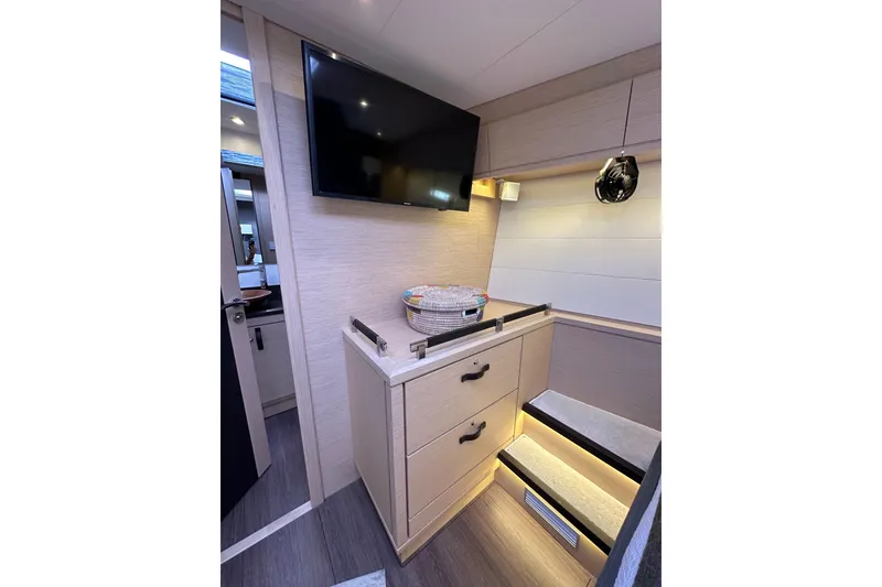 Slide: The Image of Luxurious interior of 2017 Jeanneau 64 yacht with modern cabinetry and TV. - 119