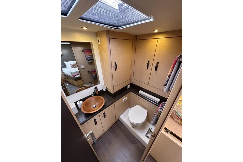 Slide: The Image of Luxurious bathroom interior of 2017 Jeanneau 64 yacht with modern fixtures and wooden cabinetry. - 121