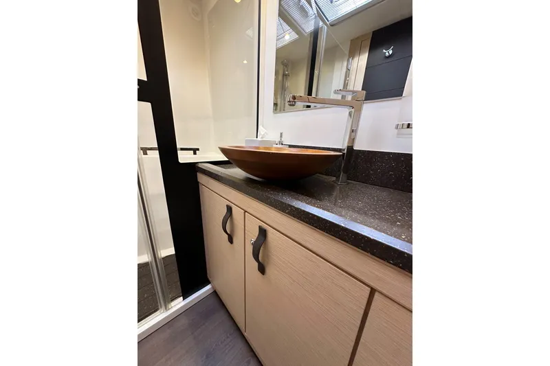 Slide: The Image of Luxurious bathroom sink area on a 2017 Jeanneau 64 yacht, featuring modern design elements. - 123