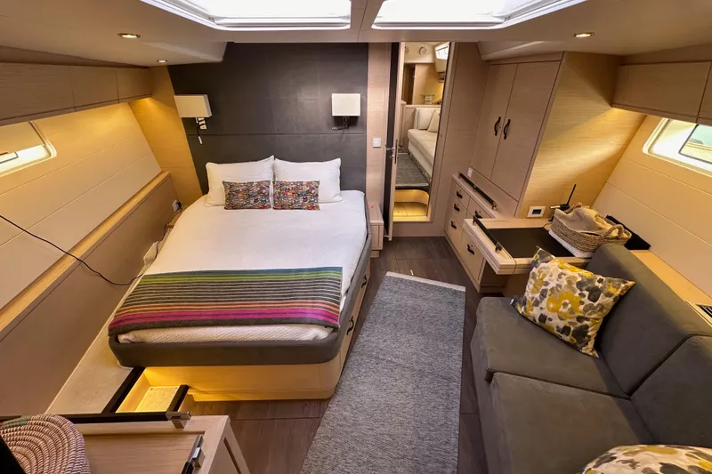Slide: The Image of Luxurious interior of a 2017 Jeanneau 64 yacht with cozy bedroom and modern furnishings. - 124