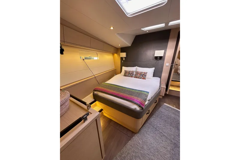 Slide: The Image of Luxurious bedroom interior of 2017 Jeanneau 64 yacht with modern design and cozy bedding. - 125