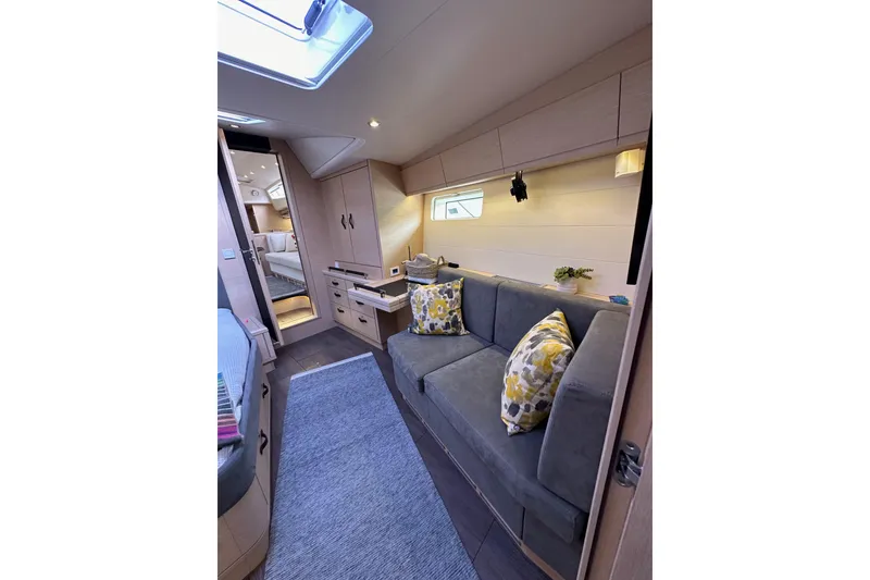 Slide: The Image of Luxurious interior of 2017 Jeanneau 64 yacht with cozy seating and modern decor. - 126