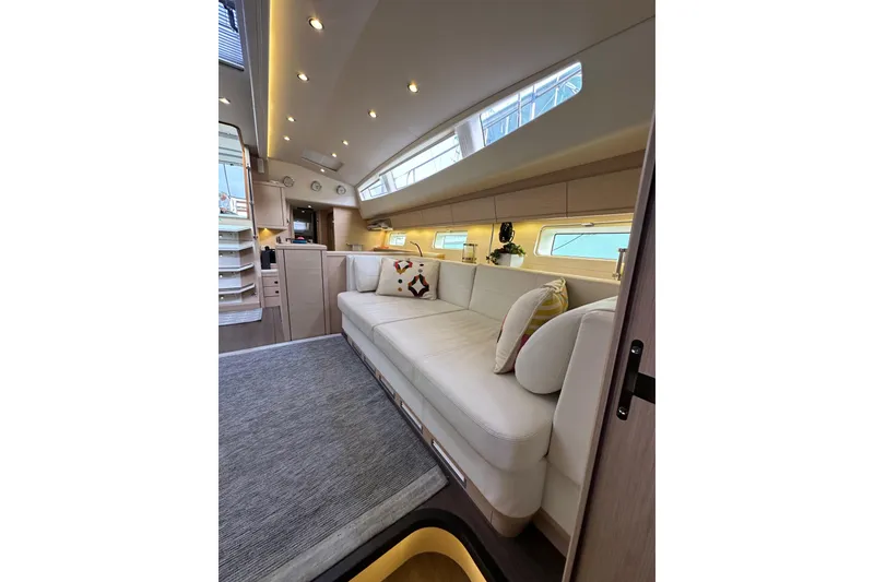 Slide: The Image of Luxurious interior of 2017 Jeanneau 64 yacht with elegant seating and modern lighting. - 128