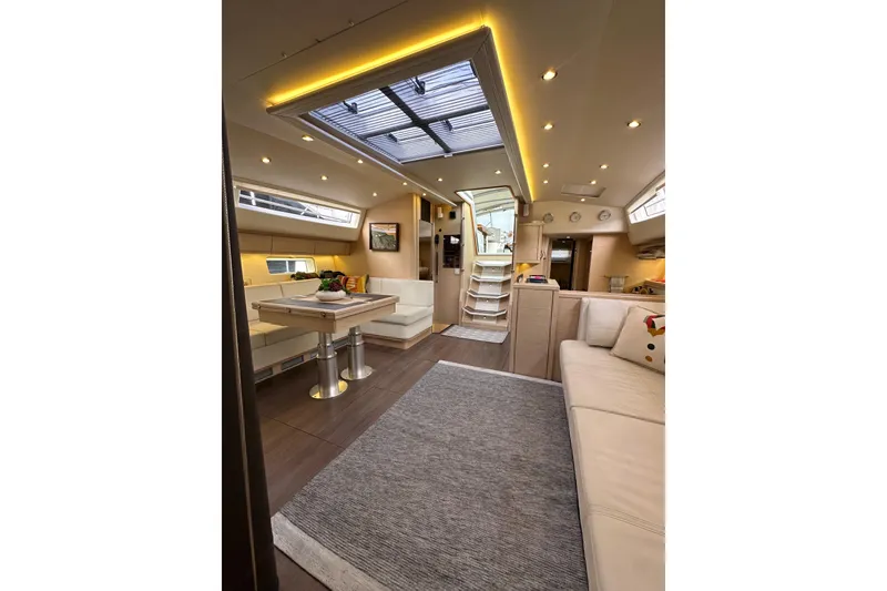 Slide: The Image of Luxurious interior of a 2017 Jeanneau 64 yacht with elegant seating and modern lighting. - 129