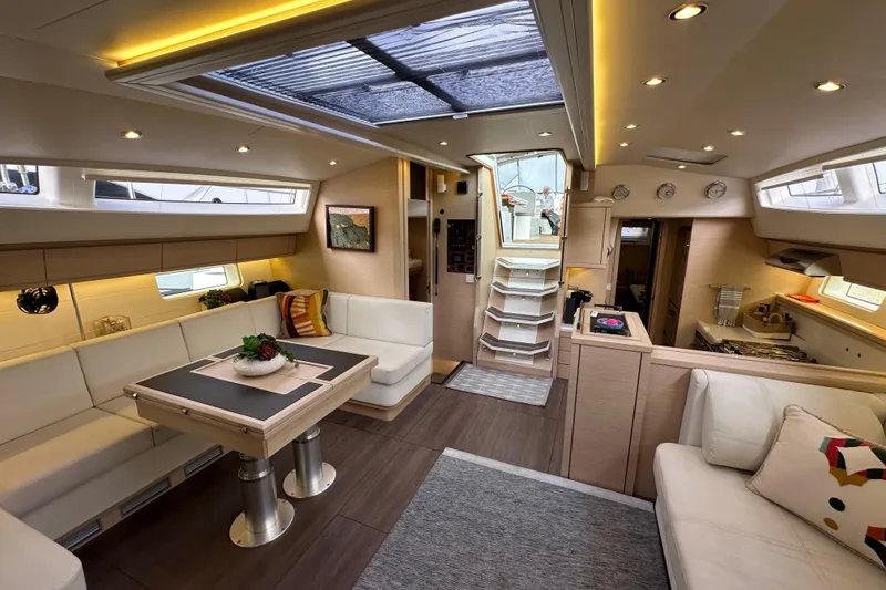 Slide: The Image of Luxurious interior of a 2017 Jeanneau 64 yacht with modern furnishings and ambient lighting. - 130