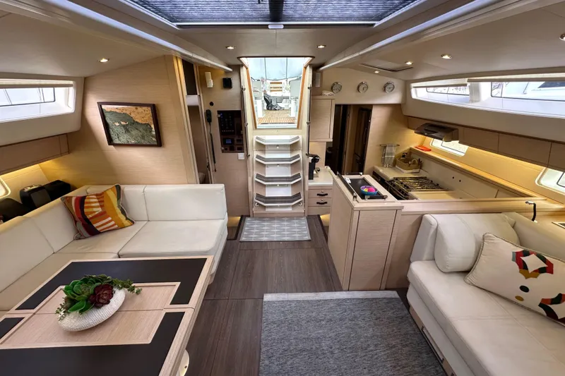 Slide: The Image of Luxurious interior of a 2017 Jeanneau 64 yacht with modern furnishings and elegant design. - 131