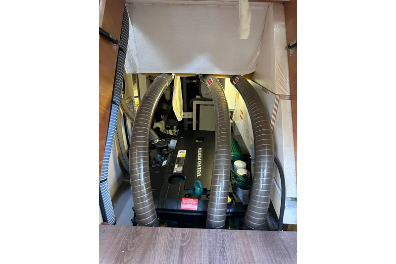 Slide: The Image of Engine room of 2017 Jeanneau 64 yacht with Volvo Penta engine and ventilation hoses. - 132