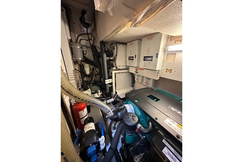 Slide: The Image of Engine room of 2017 Jeanneau 64 yacht, featuring complex machinery and equipment. - 134