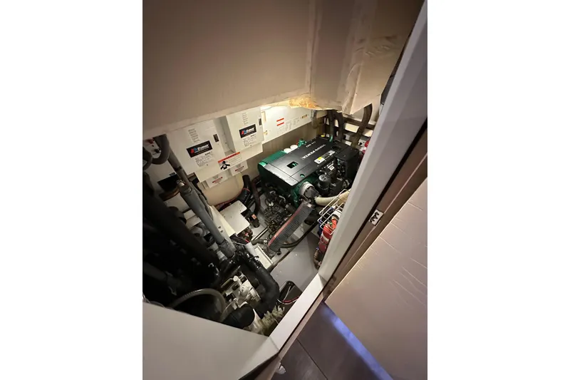 Slide: The Image of Engine room of 2017 Jeanneau 64 yacht, featuring mechanical components and wiring. - 137