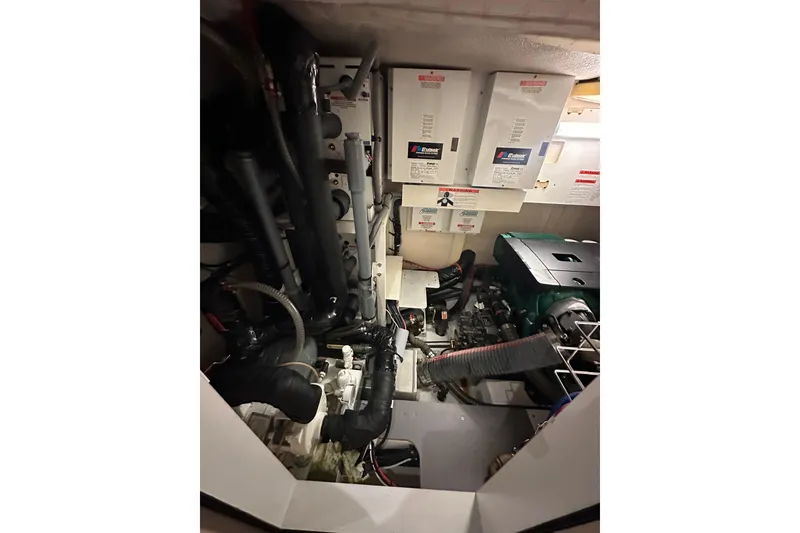 Slide: The Image of Engine room of 2017 Jeanneau 64 yacht, featuring complex machinery and wiring. - 138