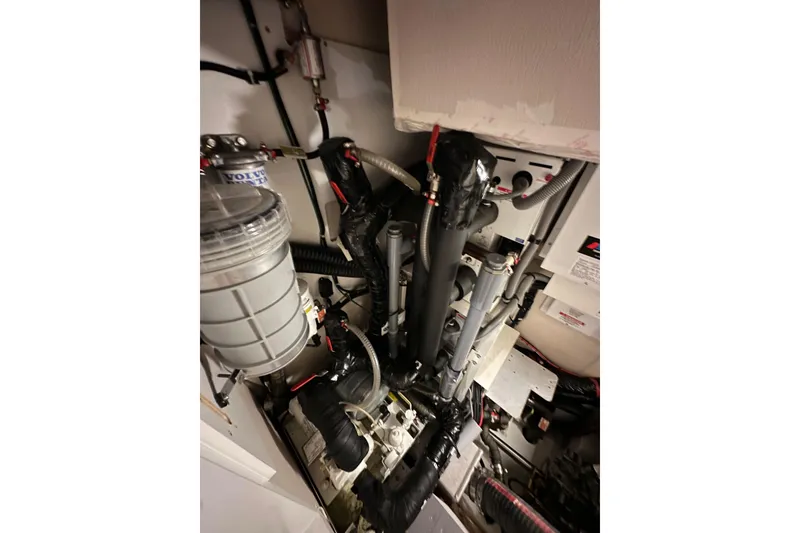 Slide: The Image of Engine room of a 2017 Jeanneau 64 yacht, showcasing mechanical components. - 140