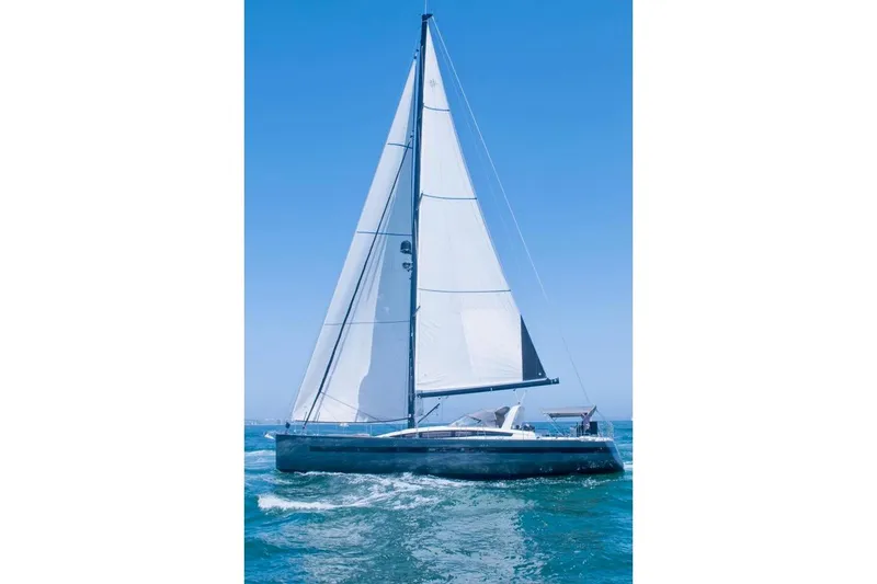 Slide: The Image of 2017 Jeanneau 64 sailboat navigating blue ocean waters under clear skies. - 147