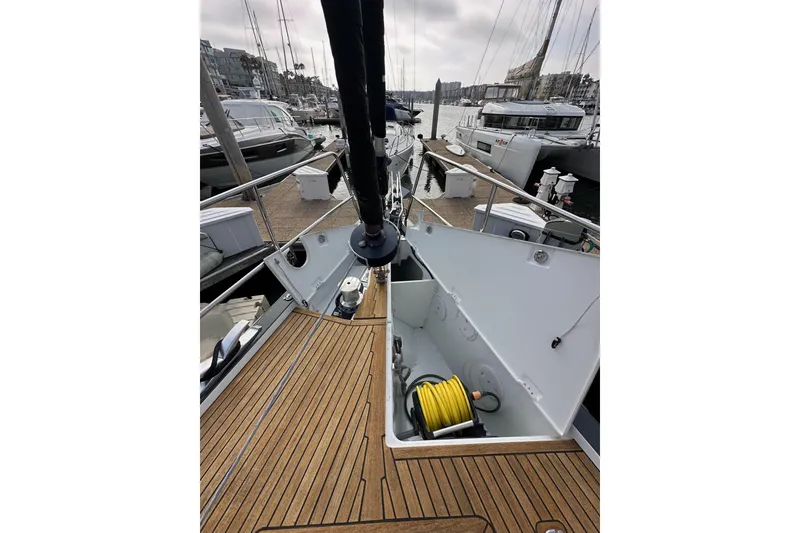 Slide: The Image of 2017 Jeanneau 64 yacht deck with open storage compartment at marina. - 22