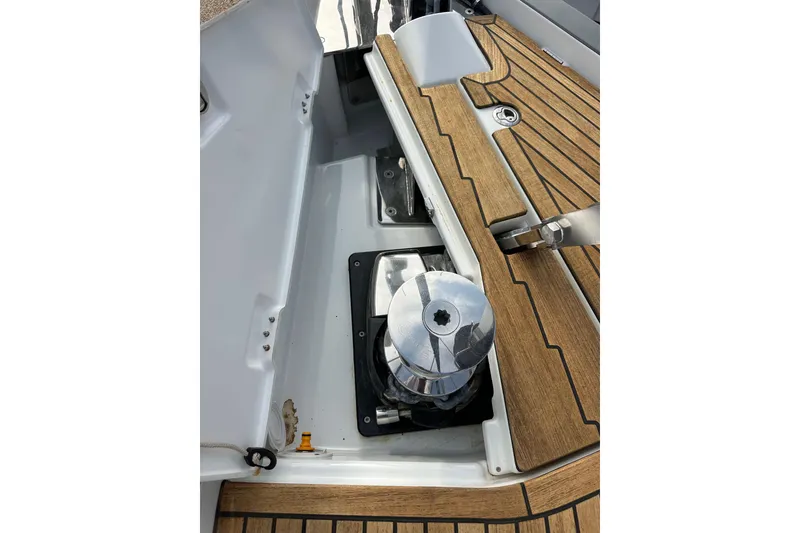 Slide: The Image of 2017 Jeanneau 64 yacht deck with winch and teak flooring. - 25