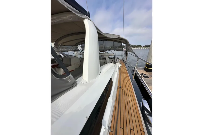 Slide: The Image of 2017 Jeanneau 64 yacht with teak deck, docked by the water. - 33