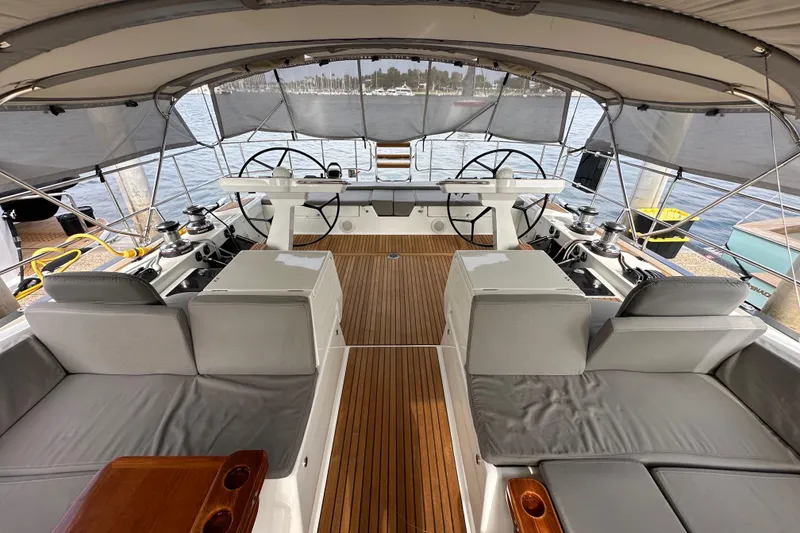 Slide: The Image of Luxurious 2017 Jeanneau 64 yacht cockpit with dual steering wheels and teak flooring. - 36