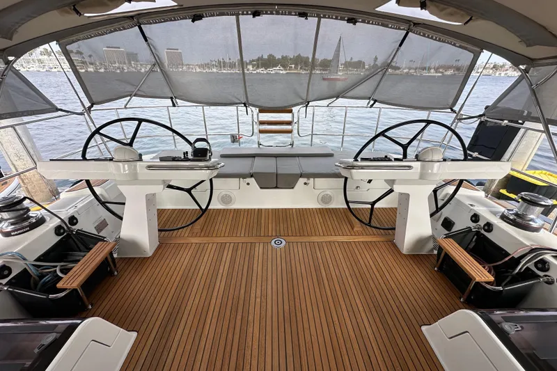 Slide: The Image of Luxurious 2017 Jeanneau 64 yacht cockpit with dual steering wheels and teak flooring. - 37