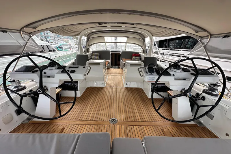 Slide: The Image of Luxurious 2017 Jeanneau 64 yacht cockpit with dual steering wheels and teak flooring. - 42