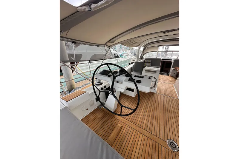 Slide: The Image of Luxurious 2017 Jeanneau 64 yacht cockpit with wooden flooring and modern steering wheel. - 43