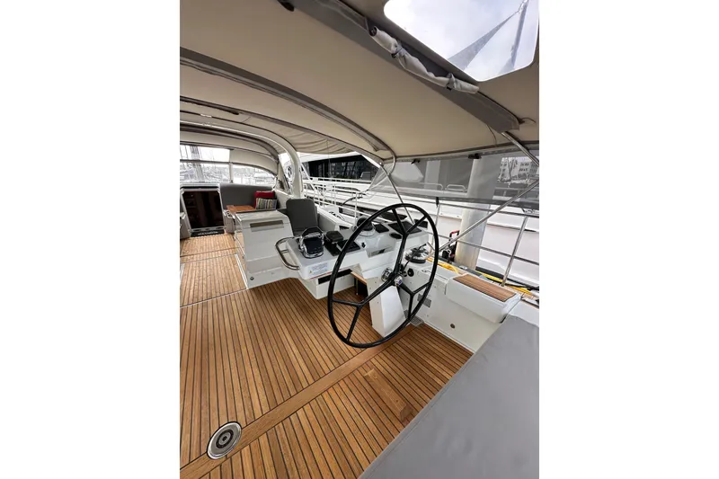 Slide: The Image of Cockpit of 2017 Jeanneau 64 yacht with teak flooring and dual steering wheels. - 44