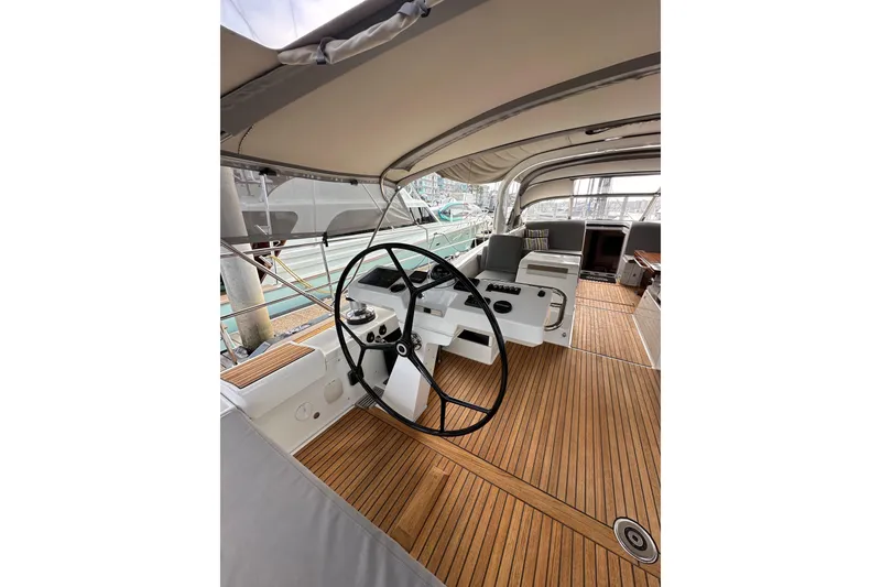 Slide: The Image of 2017 Jeanneau 64 yacht cockpit with wooden deck and steering wheel. - 45