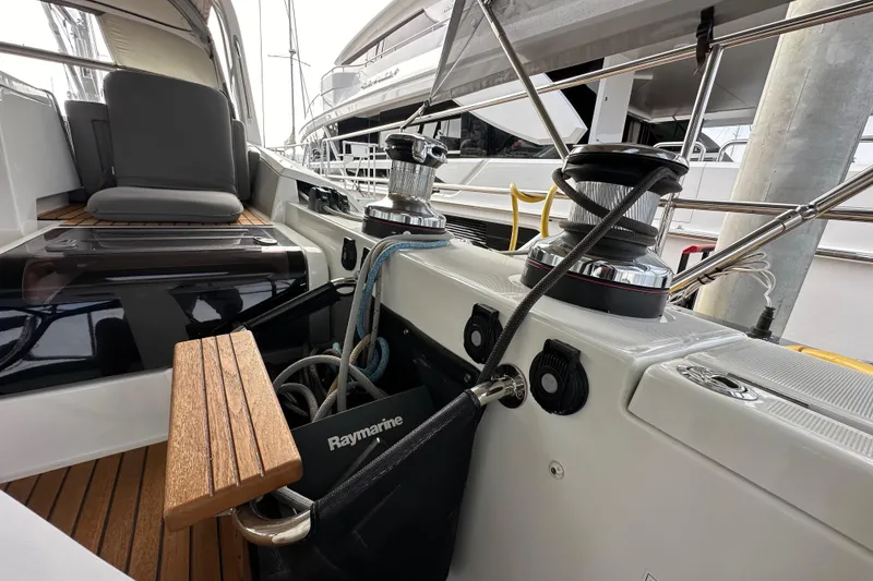 Slide: The Image of 2017 Jeanneau 64 yacht deck with winches and seating area. - 51