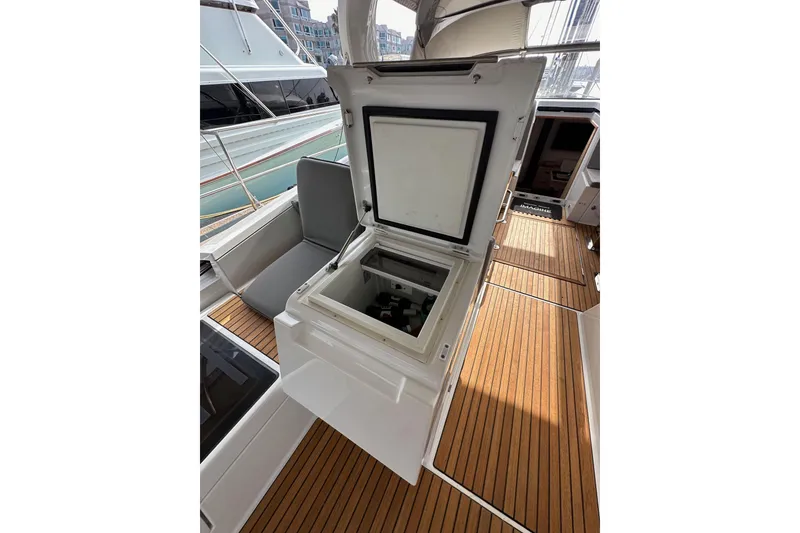 Slide: The Image of Open storage compartment on 2017 Jeanneau 64 yacht with teak deck. - 58