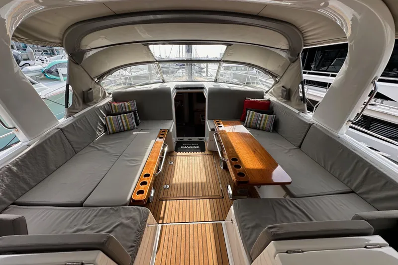 Slide: The Image of Luxurious 2017 Jeanneau 64 yacht interior with spacious seating and elegant wooden table. - 60