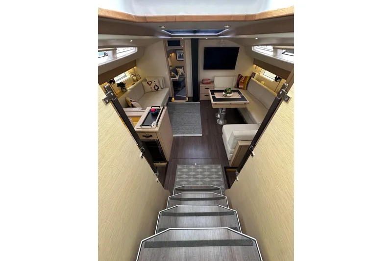 Slide: The Image of Luxurious interior of 2017 Jeanneau 64 yacht with modern seating and dining area. - 66