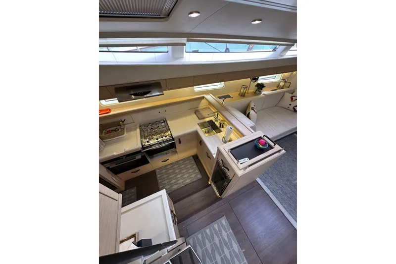 Slide: The Image of Luxurious interior of 2017 Jeanneau 64 yacht featuring modern kitchen and seating area. - 68