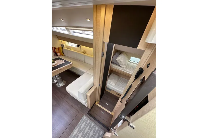 Slide: The Image of Luxurious interior of 2017 Jeanneau 64 yacht with cozy seating and bunk beds. - 69