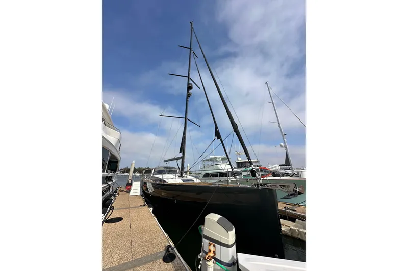 Slide: The Image of 2017 Jeanneau 64 yacht docked at marina under clear blue sky. - 7