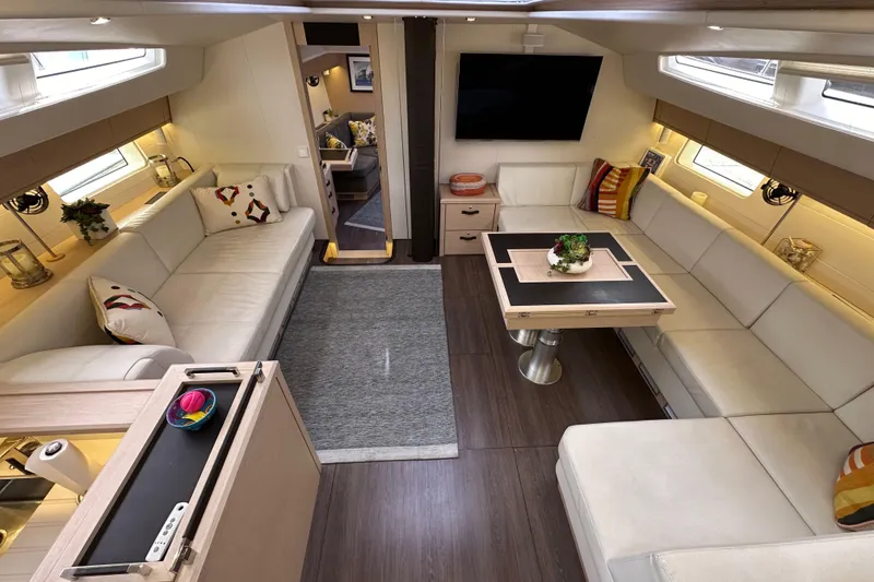 Slide: The Image of Luxurious interior of a 2017 Jeanneau 64 yacht with elegant seating and modern decor. - 70