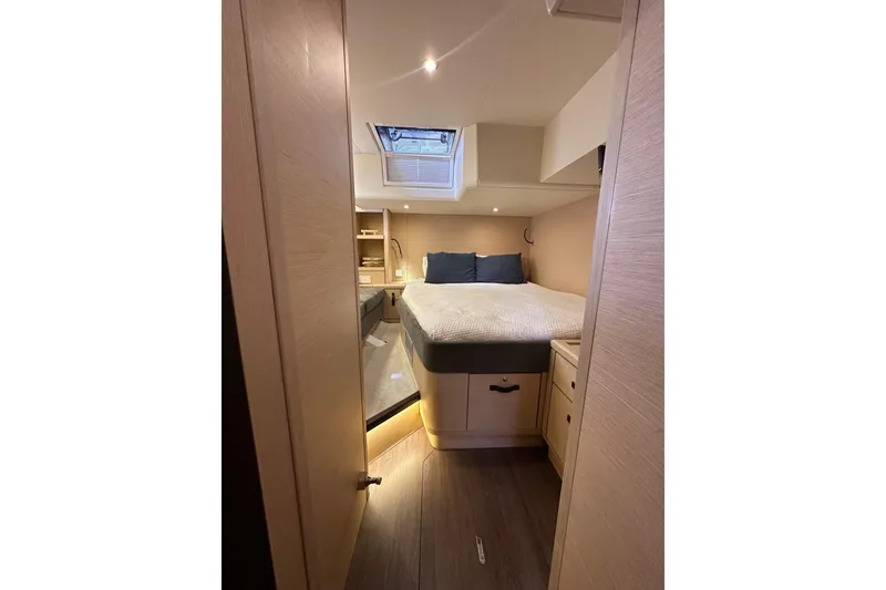 Slide: The Image of Luxurious cabin interior of 2017 Jeanneau 64 yacht with cozy bed and skylight. - 78