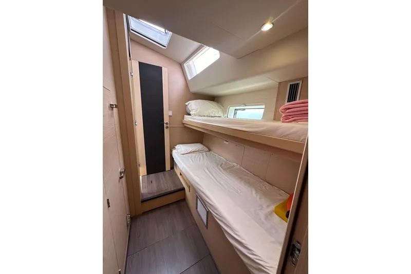 Slide: The Image of Cozy cabin with bunk beds in a 2017 Jeanneau 64 yacht, featuring natural light and modern design. - 87