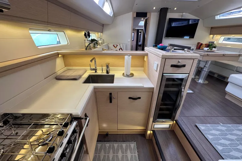 Slide: The Image of Luxurious 2017 Jeanneau 64 yacht interior with modern kitchen and elegant dining area. - 91