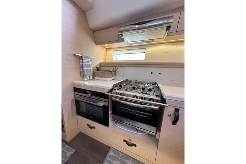 Slide: The Image of Modern kitchen in 2017 Jeanneau 64 yacht with stove, oven, and sleek cabinetry. - 93