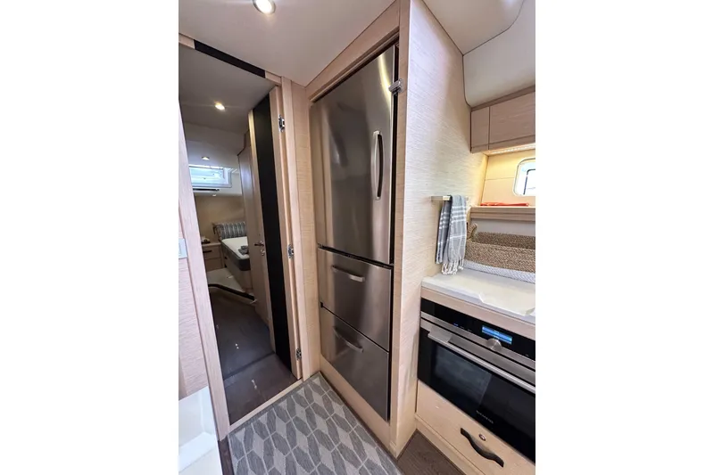 Slide: The Image of Modern kitchen interior of 2017 Jeanneau 64 yacht with stainless steel appliances. - 94