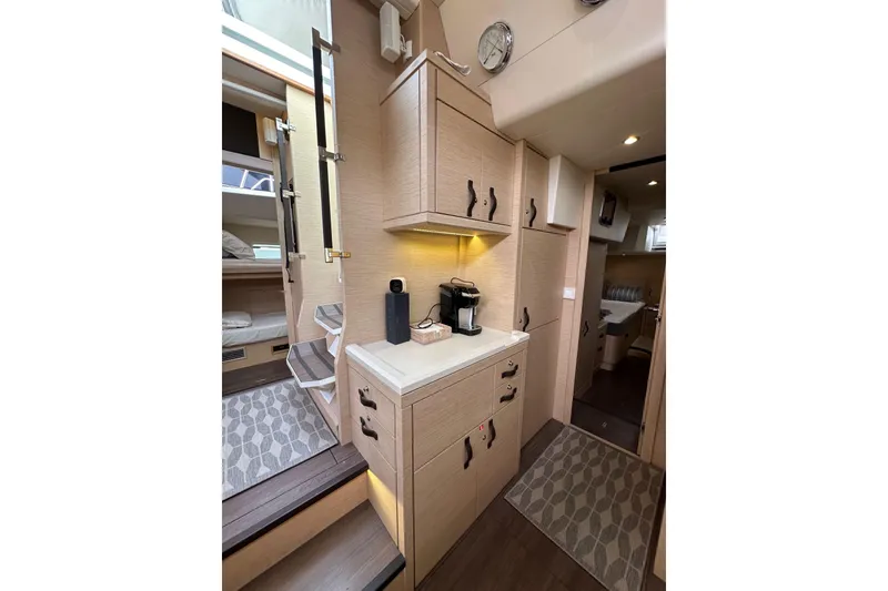 Slide: The Image of Interior of 2017 Jeanneau 64 yacht with modern cabinetry and cozy living space. - 95