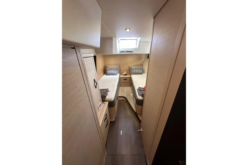 Slide: The Image of Luxurious cabin interior of 2017 Jeanneau 64 yacht with twin beds and modern decor. - 97